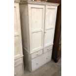 A Victorian painted pine cupboard of child friendly proportions, the pair of panelled doors over two