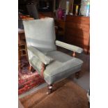 An Edwardian green dralon upholstered open armchair