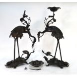 A pair of Japanese metal alloy figures of Manchurian tsuru; each bird standing on a minogame