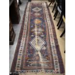 Antique worn caucasian runner with geometric medallions on blue ground within a double guarded