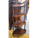 A Victorian rosewood four tier what not with barley twist supports