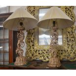 A pair of large gilded and painted table lamps with pleated cream shades