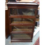 A three glazed section library bookcase in the Globe Wernicke style, on a plinth base to/w another