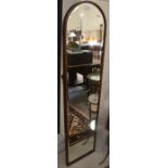 A wood framed bevelled edge full length mirror