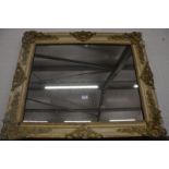 A Continental cream painted mirror with applied foliate mouldings