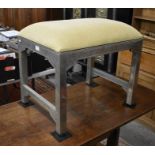 Overstuffed footstool on metal cased frame