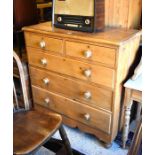 Antique pine chest of two short over three drawers with turned  pulls raised on bun feet