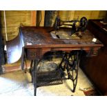 A mahogany and iron treadle sewing machine