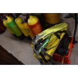 A collection of diving equipment to include air tanks, diving weights, fins, regulators and other