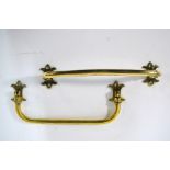 A pair of hinged brass umbrella stand brackets