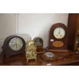 A burr walnut inlaid twin train mantel clock, an oak mantel clock, a barometer, clock case and a