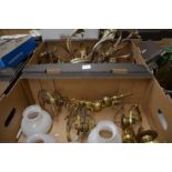 Two boxes containing a pair of foliate and floral gilt metal wall lights, two pairs of brass wall
