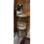 A French gilt metal three tier vanity unit with swing mirror to top and circular etched glass