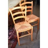 A set of eight modern beech rush seated ladder back dining chairs to/w a pair of similar painted