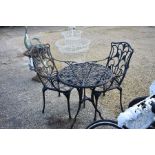 Victorian style three piece patio set comprising circular table and a pair of arm chairs