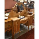 A French carved pine dressing table with  bevelled mirror over a central drawer flanked by