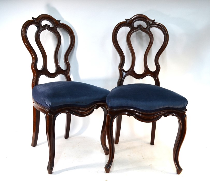 A set of six late 19th century walnut dining side chairs with overstuffed seats raised on cabriole