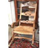 A carved hardwood rush seated rocking chair to/w a beech armchair (2)