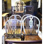 Five wheel and spindle back dining chairs with shaped elm seats