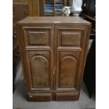 A small oak two door cabinet