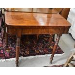 A 19th century mahogany card table, the baize lined folding top raised on turned supports with