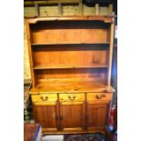 A Westminster Pine dresser with two open shelves over three drawers and panelled cupboard doors