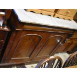 A Victorian mahogany marble top cupboard with moulded cavetto drawer over panelled doors raised on a