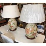 A pair of bulbous ceramic table lamps decorated with floral sprays to/w matching shades (2)