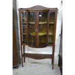 Edwardian inlaid mahogany glazed bow front display cabinet with a pair of central doors enclosing