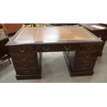 Large mahogany twin pedestal desk with gilt tooled tan leather top over nine drawers with brass