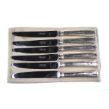 A set of six table knives with French loaded silver handles and Garrard & Co. stainless steel