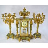 A French Empire style three piece gilt metal mounted green onyx clock garniture, the 8-day two train