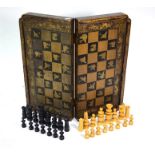 A Chinese black lacquered and gilt folding chess/backgammon board to/w a set of turned and carved