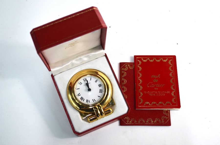 A Cartier Colisee gilt and lacquer travel alarm strut clock, no. 0500244 circa 1980, in fitted