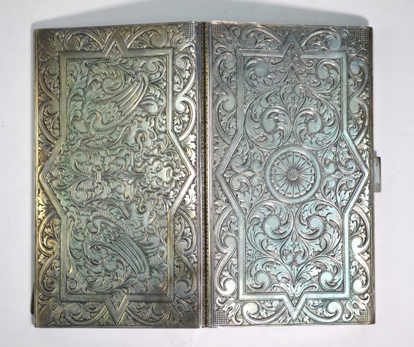 A good quality low grade silver cigarette case, profusely engraved with arabesque gryphons and - Image 2 of 2