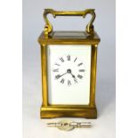 A lacquered brass 8-day carriage clock, the white enamelled dial with roman numerals, 12 cm h