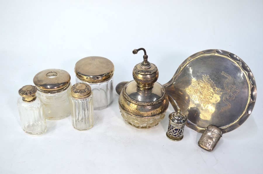 Five various cut glass toilet jars with silver mounts, including scent atomiser, to/w a silver-