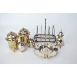 Two ovoid silver pepperettes, London 1878/91, to/w an Asprey silver toast rack, Birmingham 1912, a