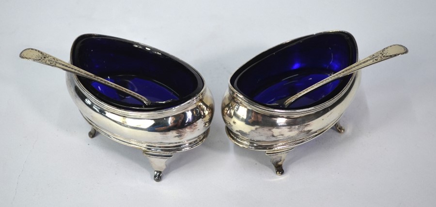 A pair of George III silver open salts of navette form, with reeded rims and scroll feet,