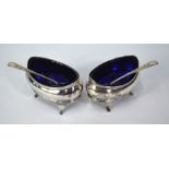 A pair of George III silver open salts of navette form, with reeded rims and scroll feet,