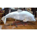 A large artisan hand carved marble dolphin sculpture, of Spanish origin circa 1980, raised on a