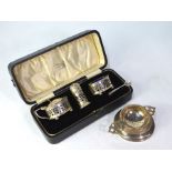 A cased silver three-piece condiment set with pierced sides and blue glass liners, Birmingham