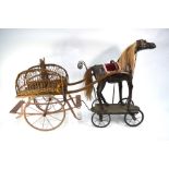 A late 19th/20th century childs toy horse and gig, the horse leather clad on steel spoked wheels,