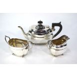 A heavy quality silver three-piece tea service in the Regency manner, with scroll handles and bun