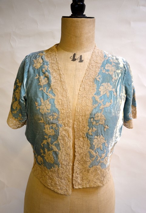 WITHDRAWN A pale blue silk velvet bed jacket edged in cream lace, a pale blue Chinese silk bed