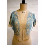 WITHDRAWN A pale blue silk velvet bed jacket edged in cream lace, a pale blue Chinese silk bed