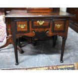 An early 18th century wide mahogany cross-banded oak low boy, the three drawers with cut brass