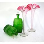 A pair of trumpet-shaped glass vases with cranberry rims, 30 cm, to/w a pair of green glass barrel-