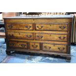 An 18th Century cross-banded oak mule chest, Lancashire, the hinged top over four dummy drawers