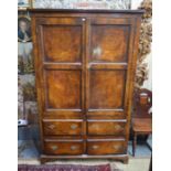 An 18th century walnut cupboard, with a pair of two panelled doors over four drawers, raised on